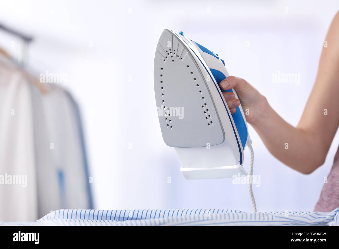 Female hand ironing clothes Stock Photo Alamy