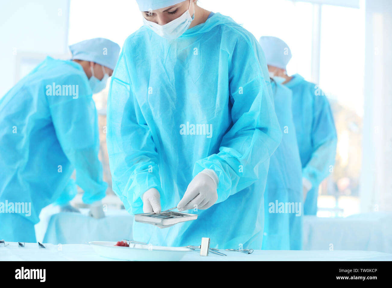 Doctor taking instruments for surgical operation in clinic Stock Photo