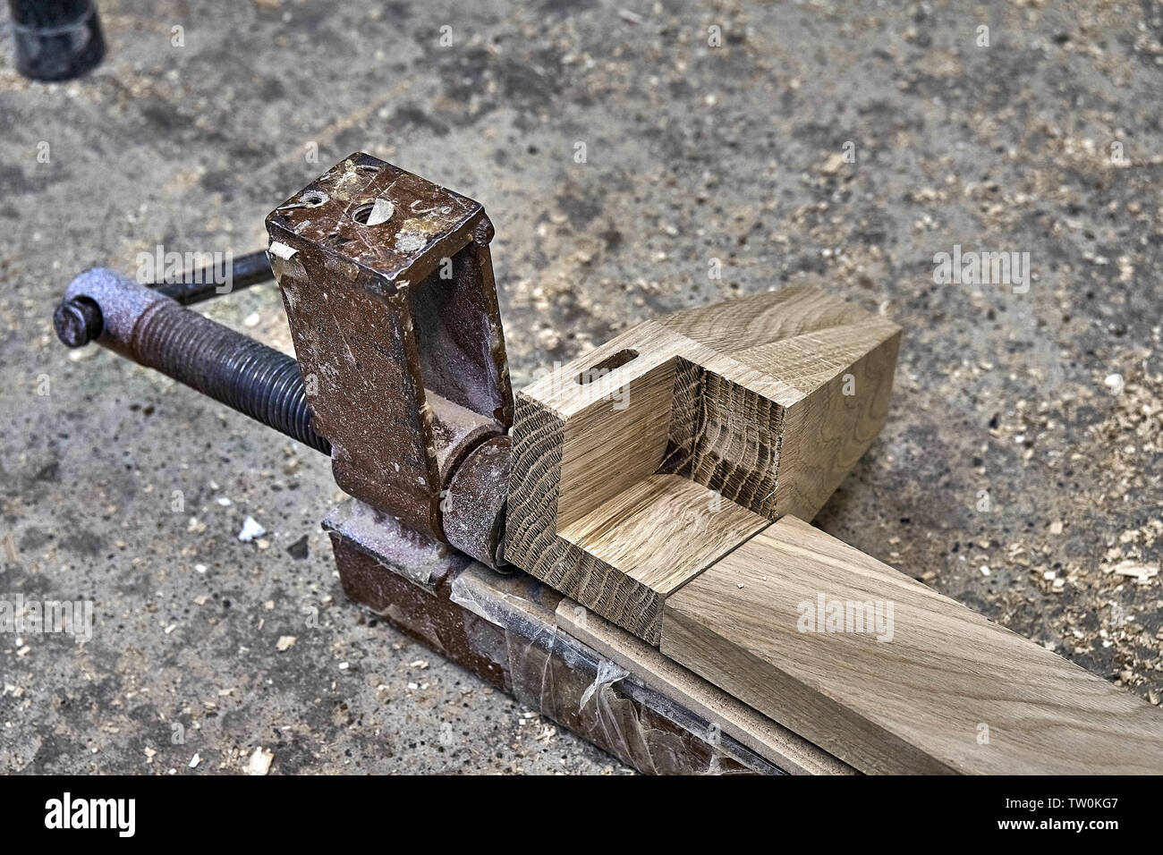 Furniture legs from solid oak. Closeup. Metal clamps tightening wooden