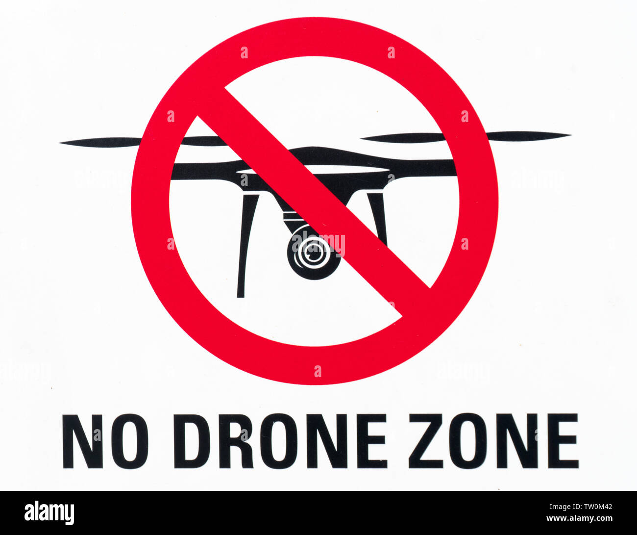 Horizontal view of an illustration sign prohibiting the use and flying of  drones with written warning of "no drone zone" in English Stock Photo -  Alamy