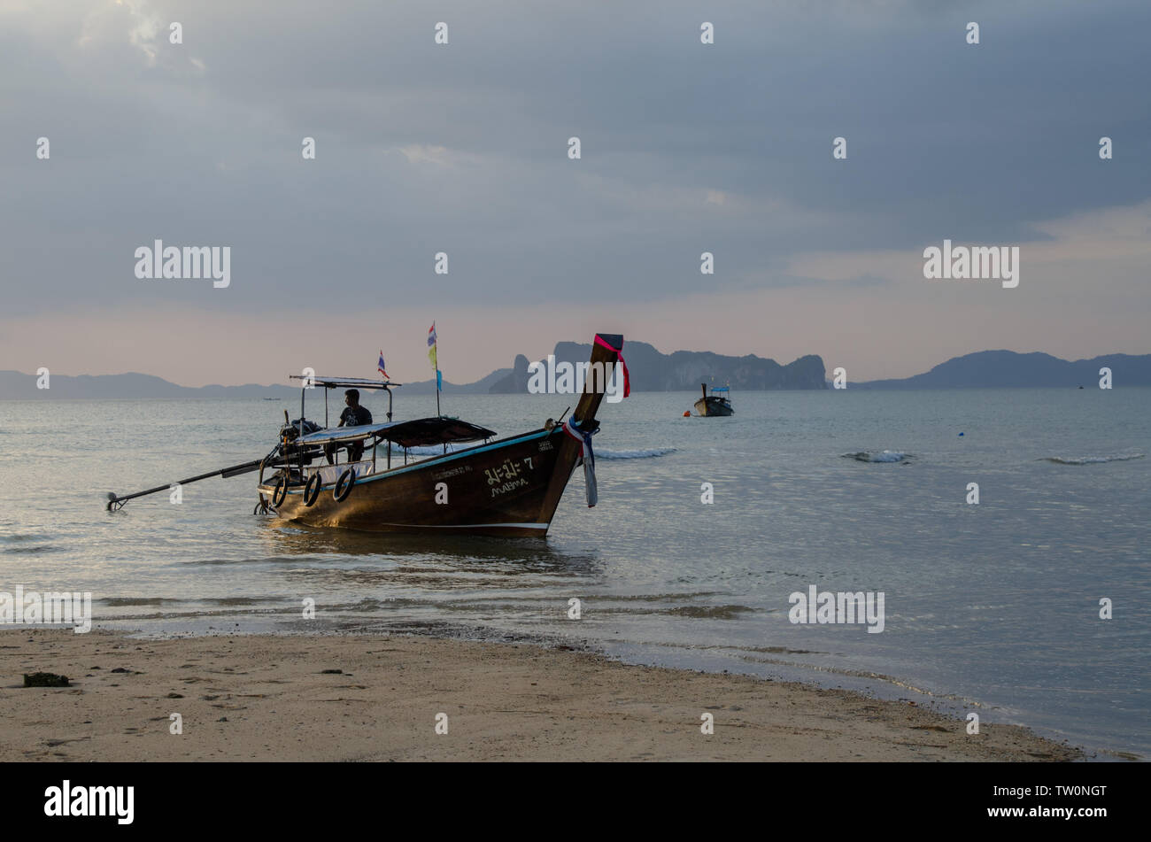 Thai long-tail boats on beach at sunset Stock Photo