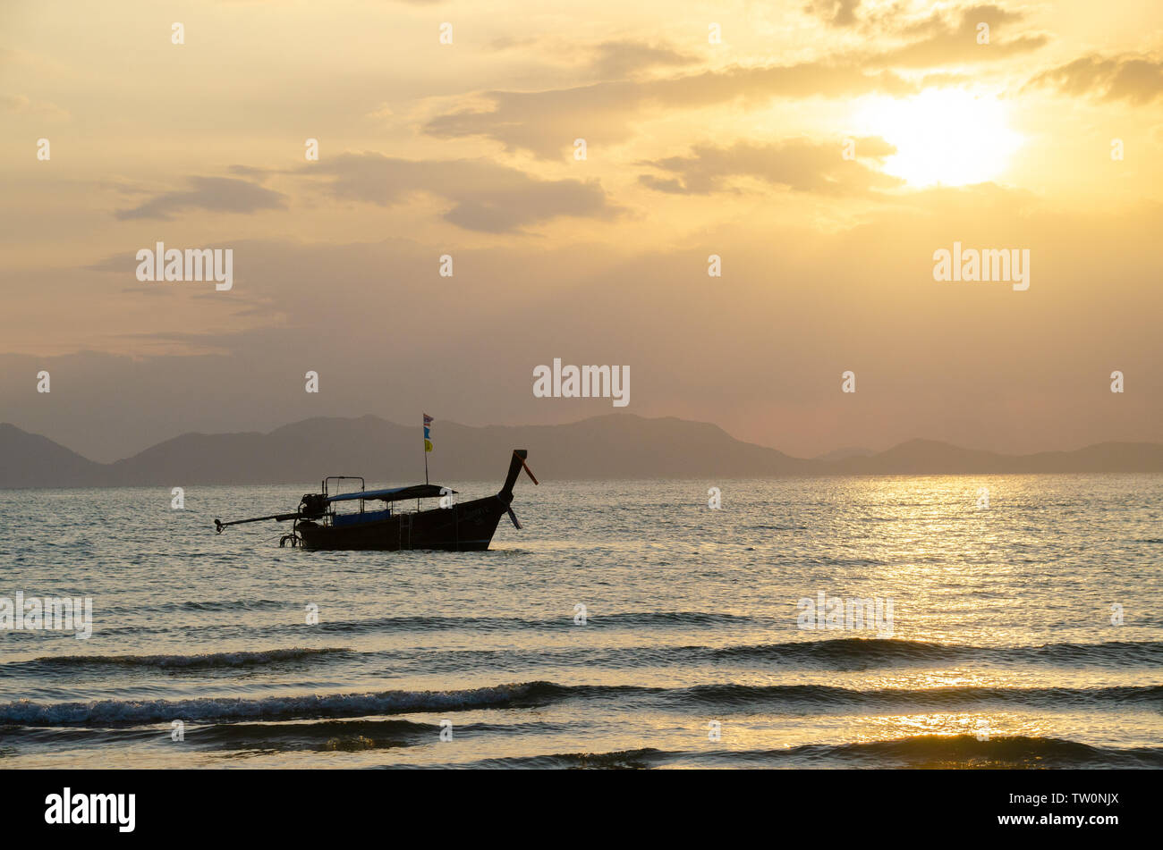 Thai long-tail boats on beach at sunset Stock Photo