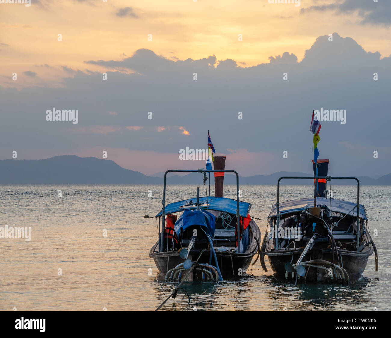 Thai long-tail boats on beach at sunset Stock Photo