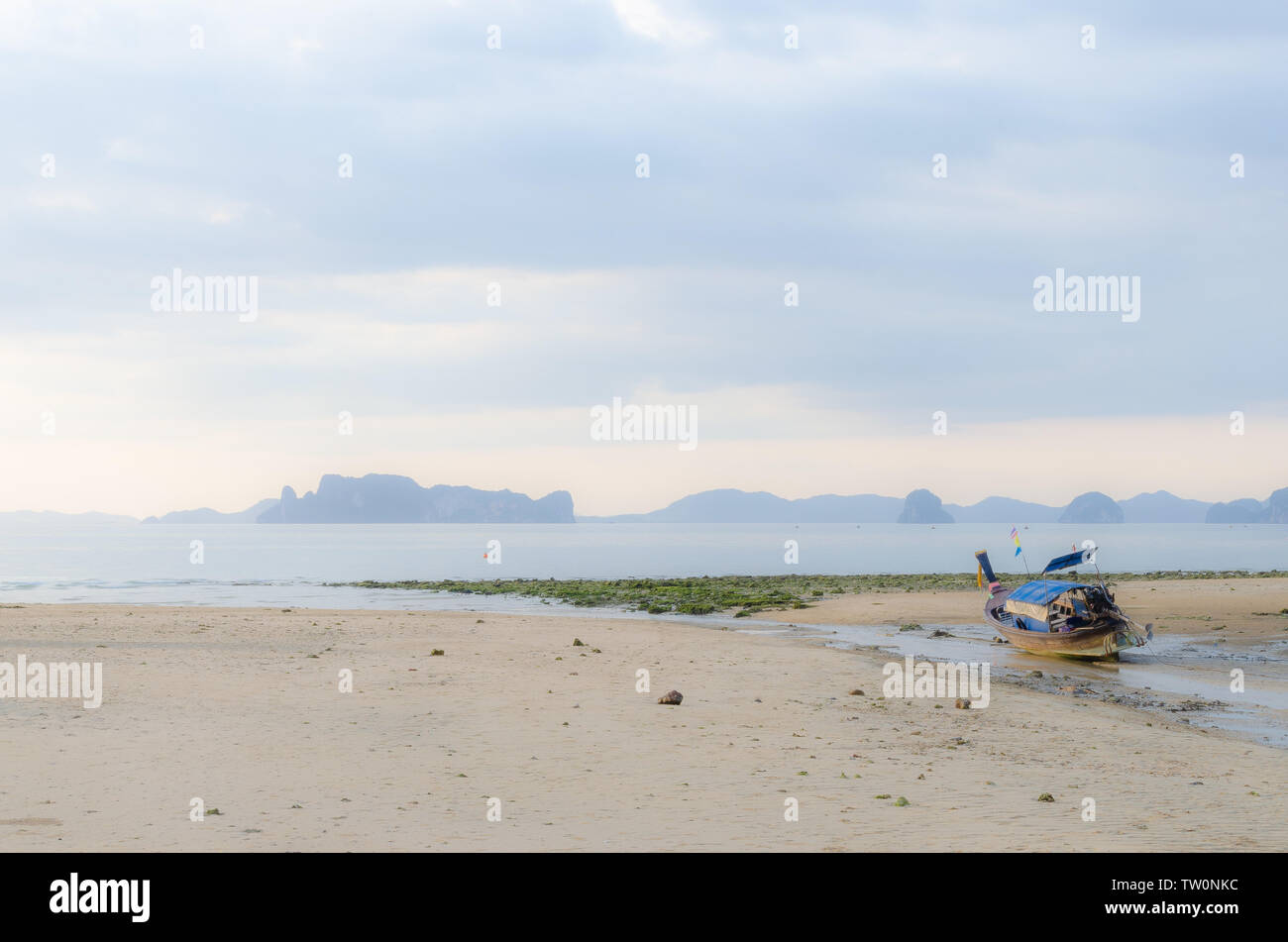 Thai long-tail boats on beach at sunset Stock Photo