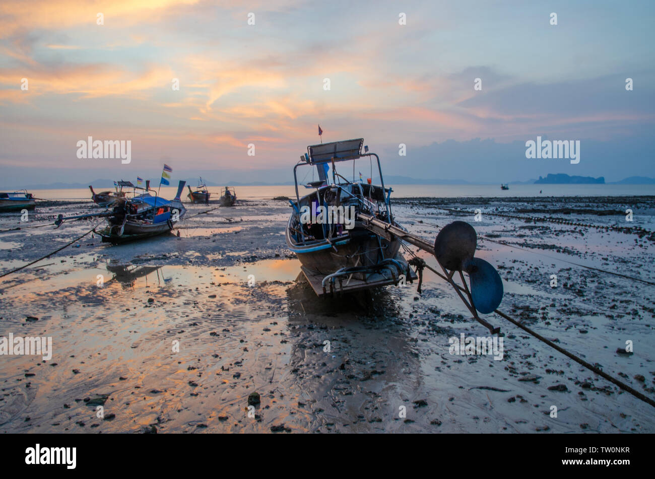 Thai long-tail boats on beach at sunset Stock Photo