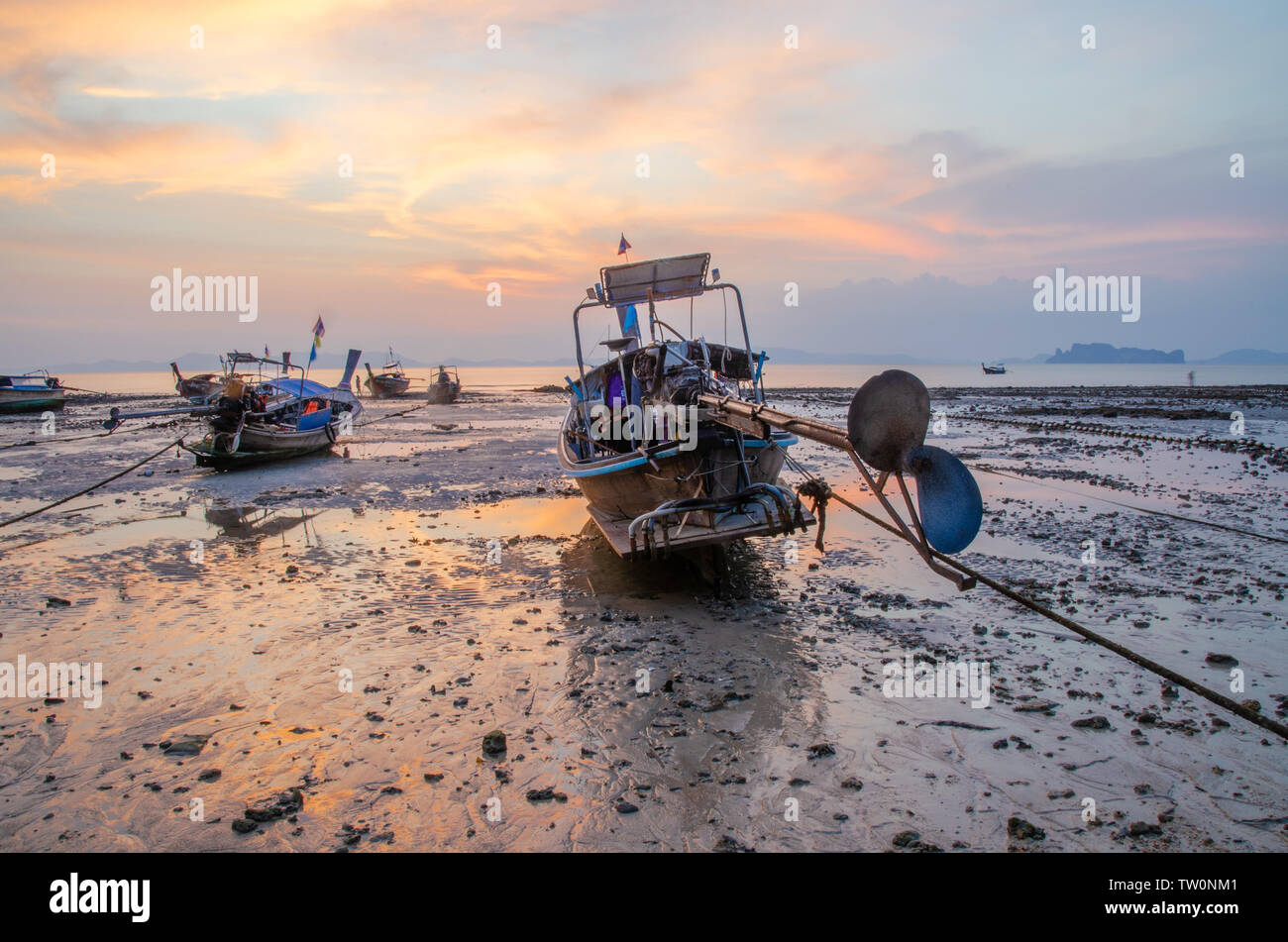 Thai long-tail boats on beach at sunset Stock Photo