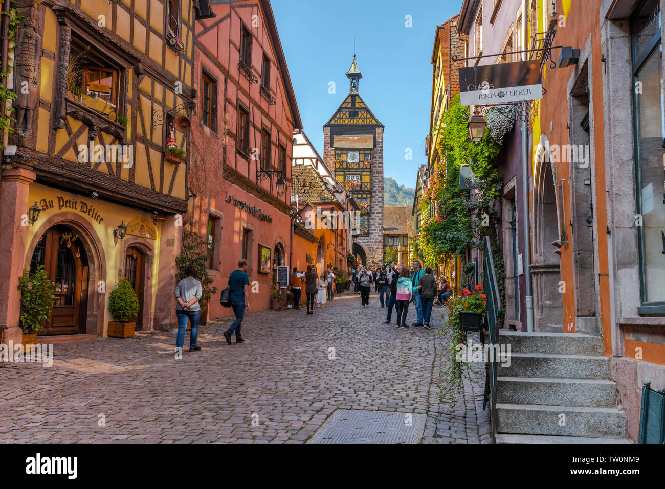 street in the old town of Riquewihr, Alsace, France, typical framework and town wall with tower Stock Photo