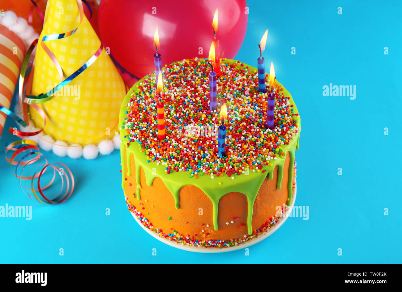 Tasty birthday cake with candles on colorful background Stock Photo - Alamy