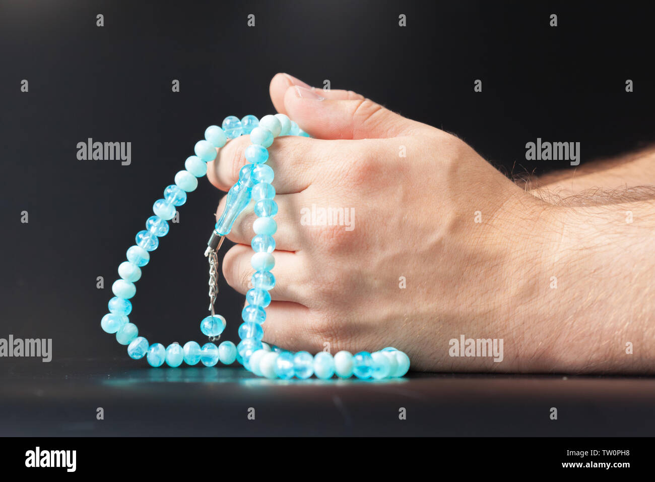 Male hand holding beads Stock Photo