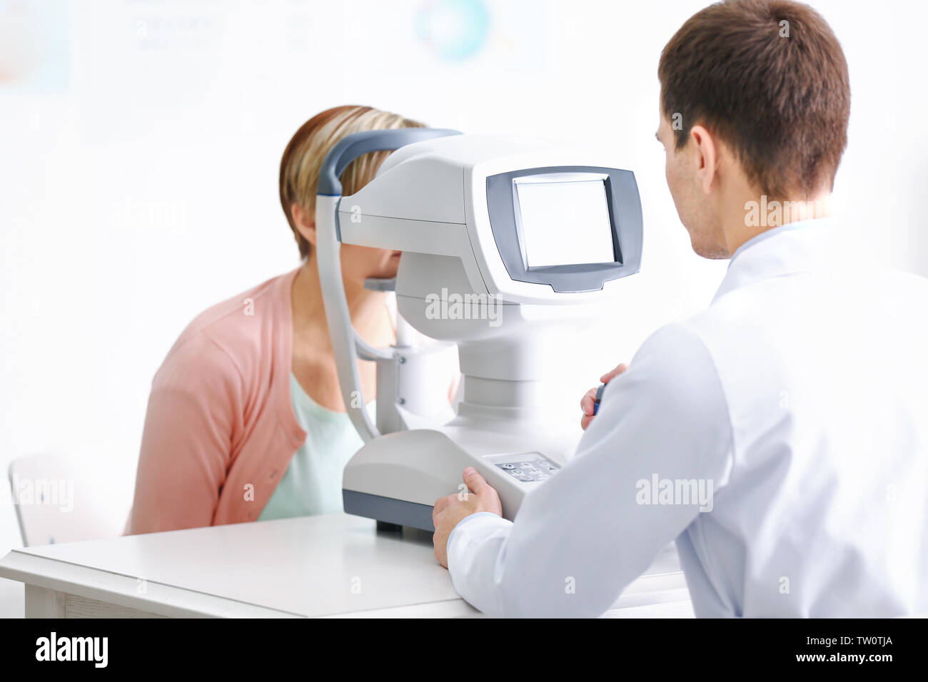 Ophthalmologist measuring intraocular pressure of woman in clinic Stock Photo