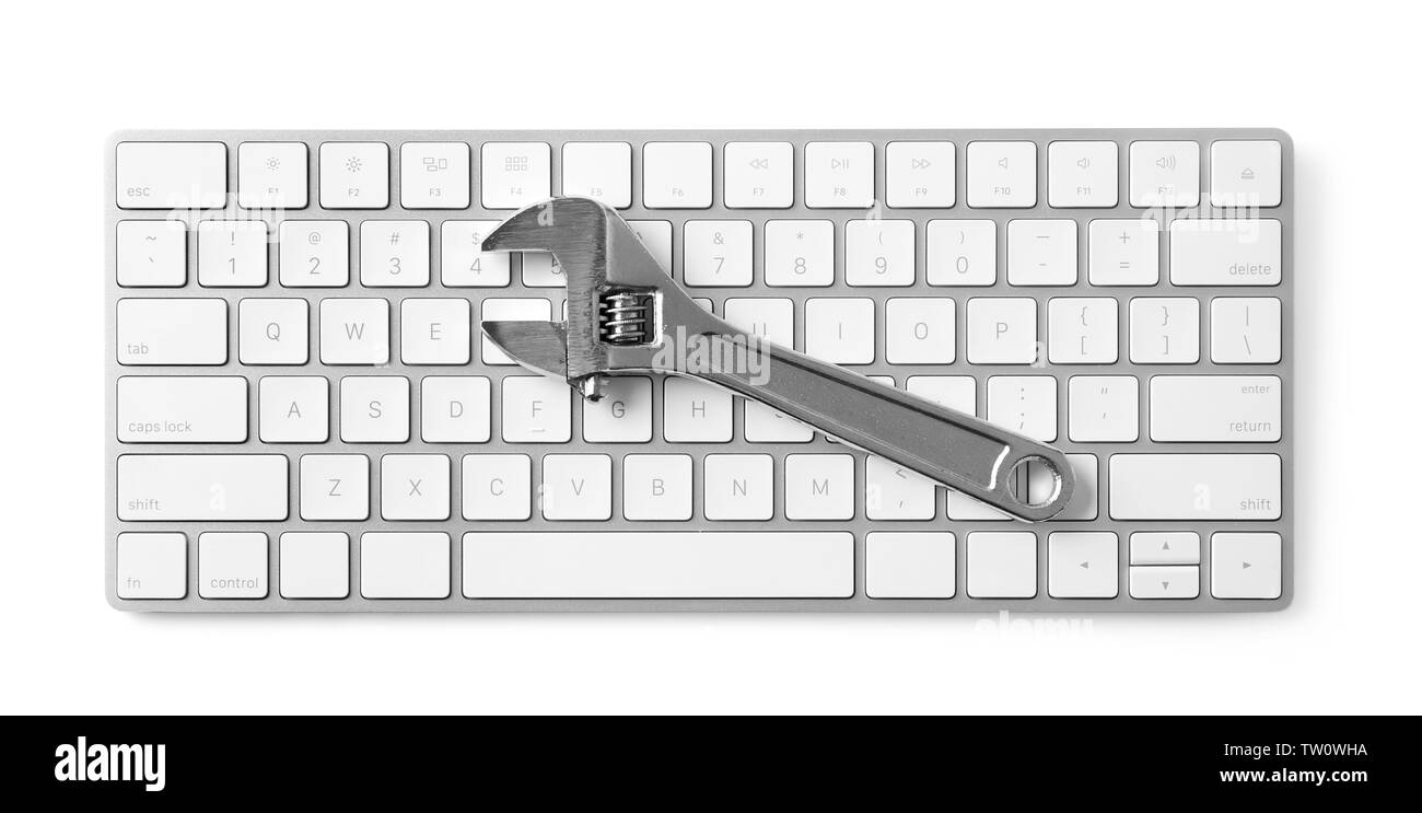Modern wireless keyboard and adjustable wrench on white background Stock Photo