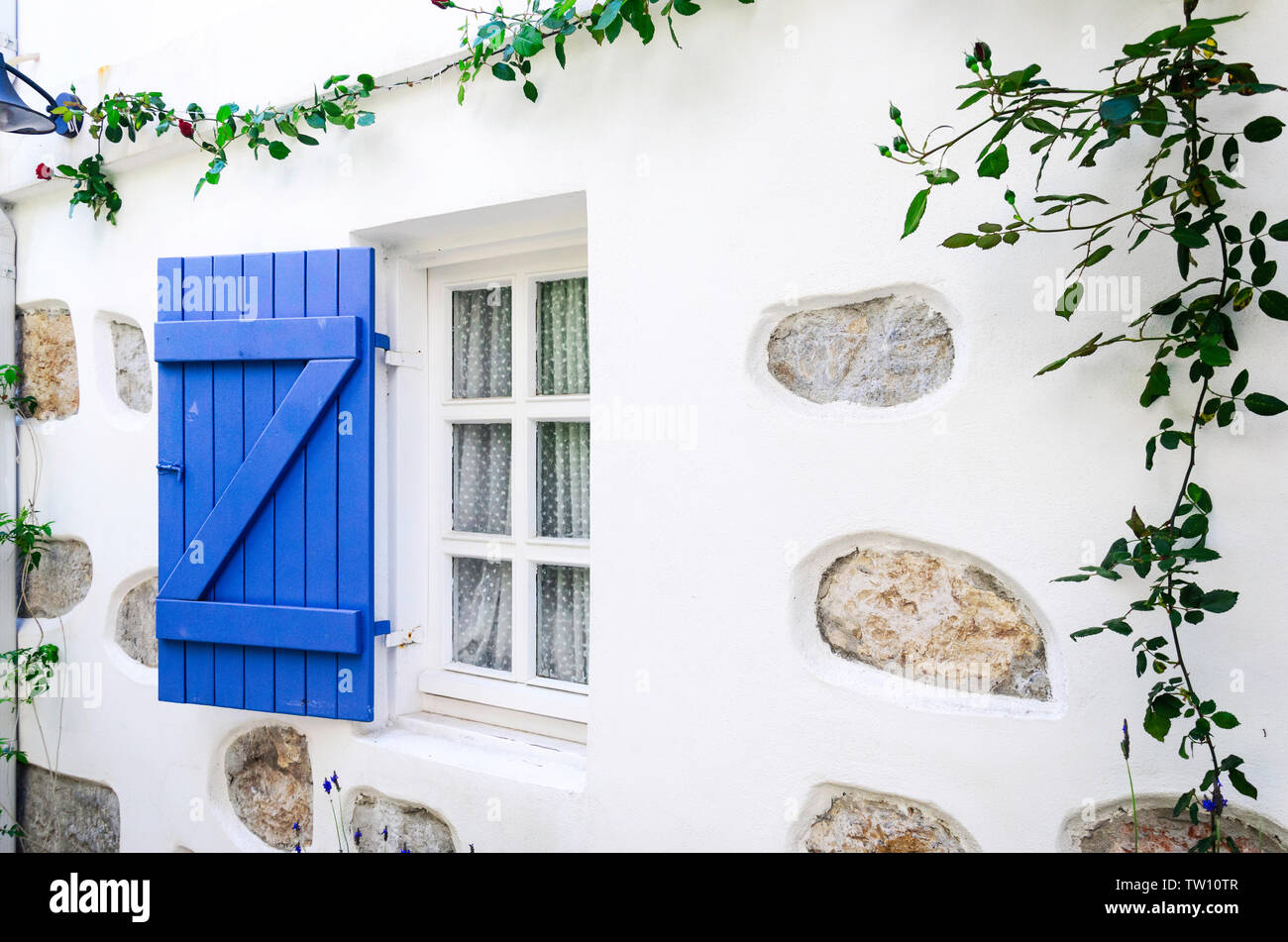 Beautiful vintage window with open blue shutters Stock Photo