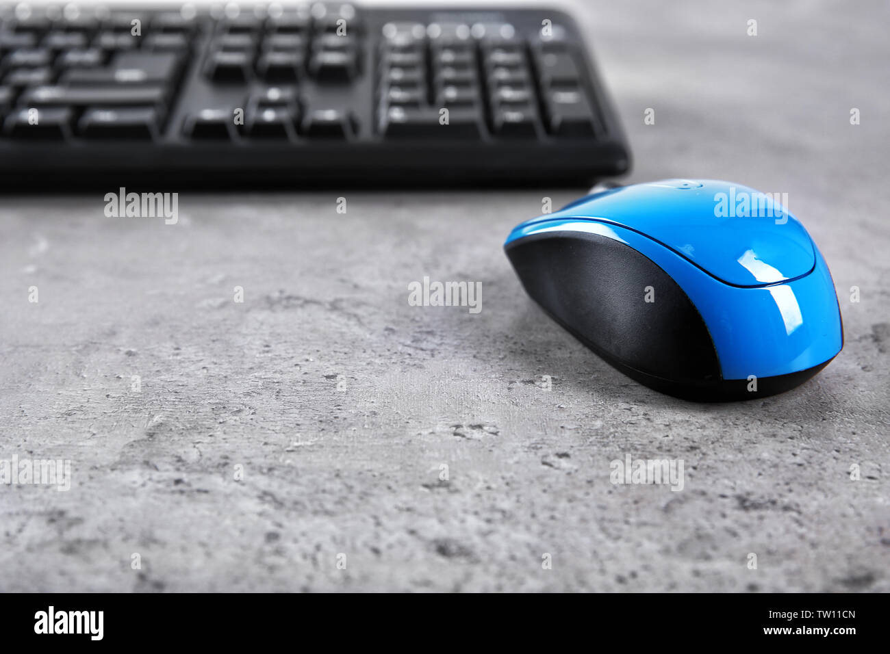 Optical mouse and computer keyboard on table Stock Photo