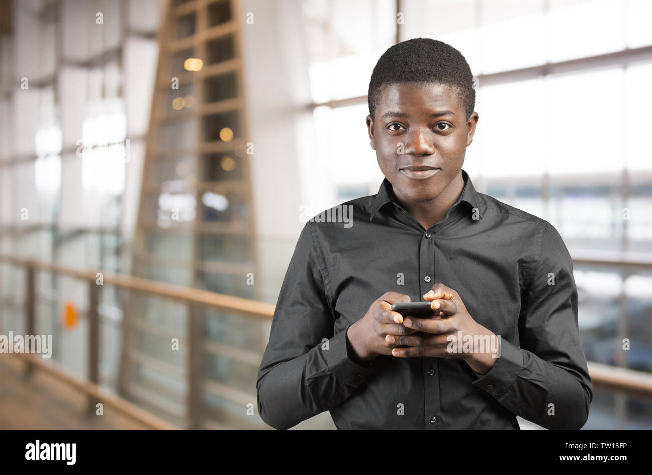Happy Afro-American Man using a Mobile Phone Stock Photo