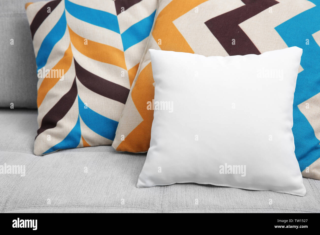 Blank soft pillow on cozy couch Stock Photo