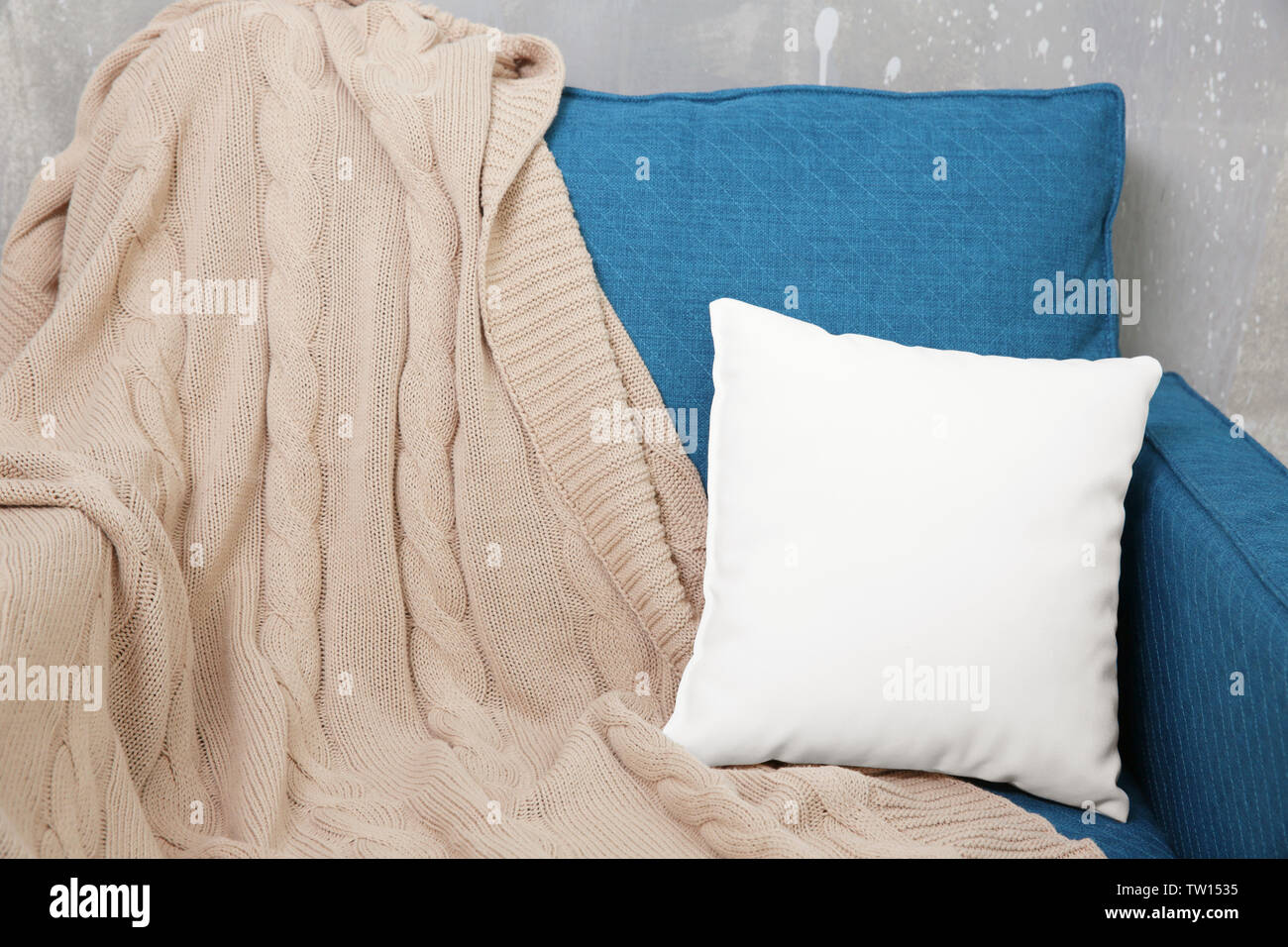 Blank soft pillow on cozy armchair Stock Photo