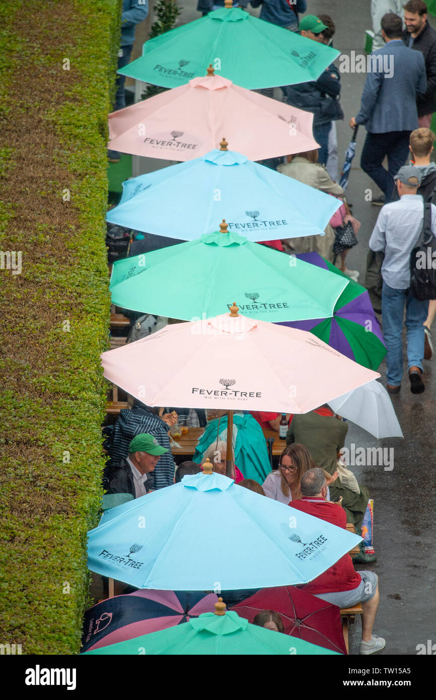 The Queens Club, London, UK. 18th June 2019. Day 2 of The Fever Tree  Championships, rain cancels all play on Day 2 leaving spectators sheltering  under umbrellas. Credit: Malcolm Park/Alamy Live News