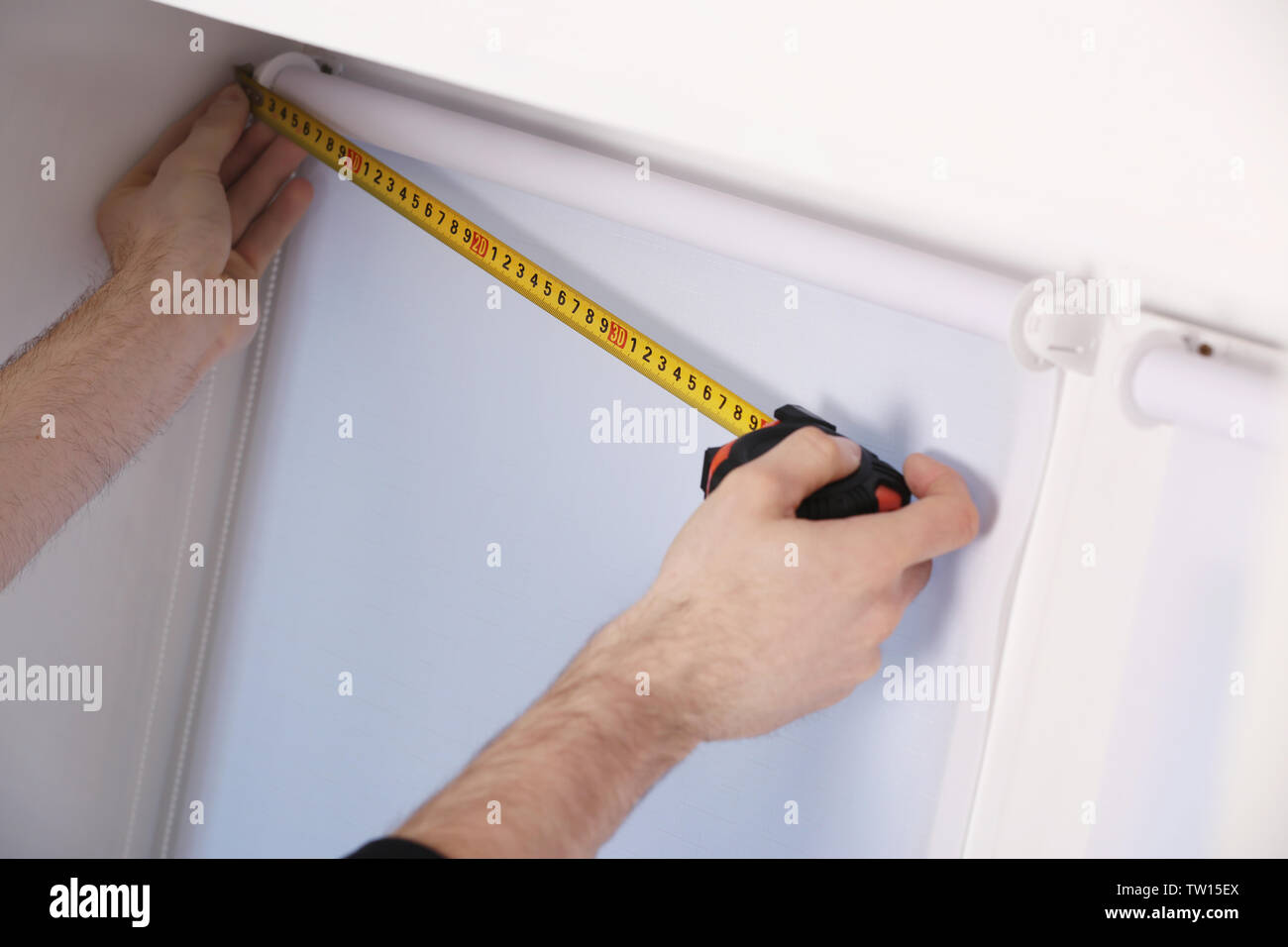 Male hands making window measurements Stock Photo