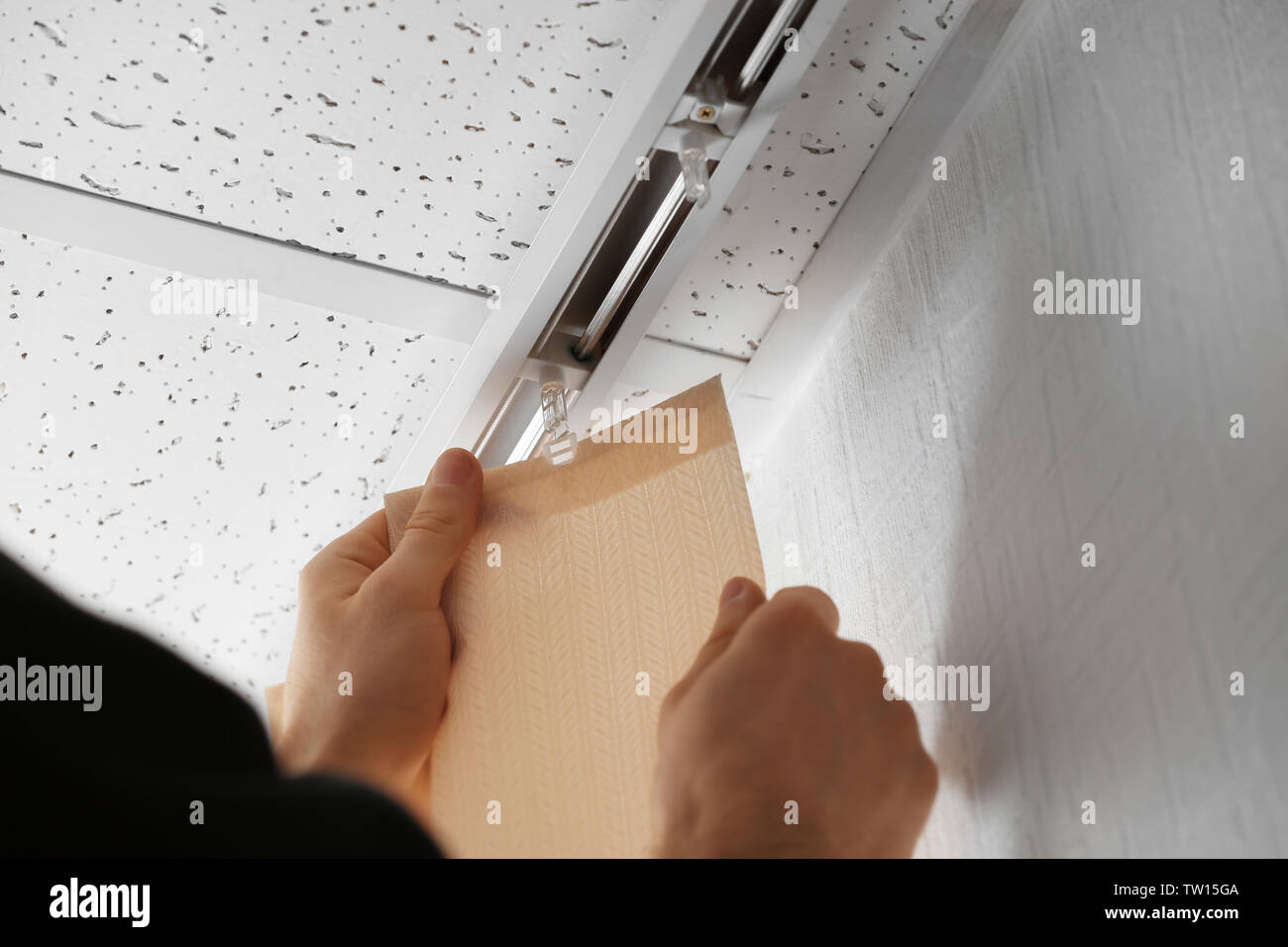 Male hands installing vertical blinds Stock Photo