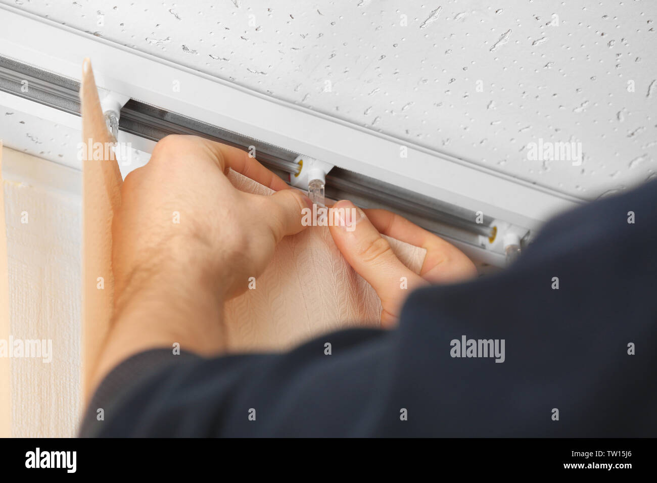 Male hands installing vertical blinds Stock Photo