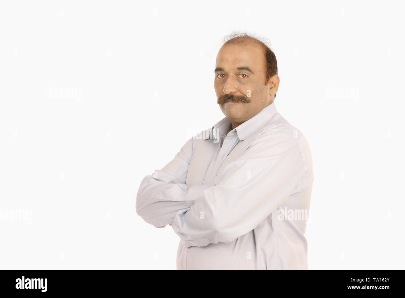 Portrait of an Indian businessman with arms crossed Stock Photo - Alamy