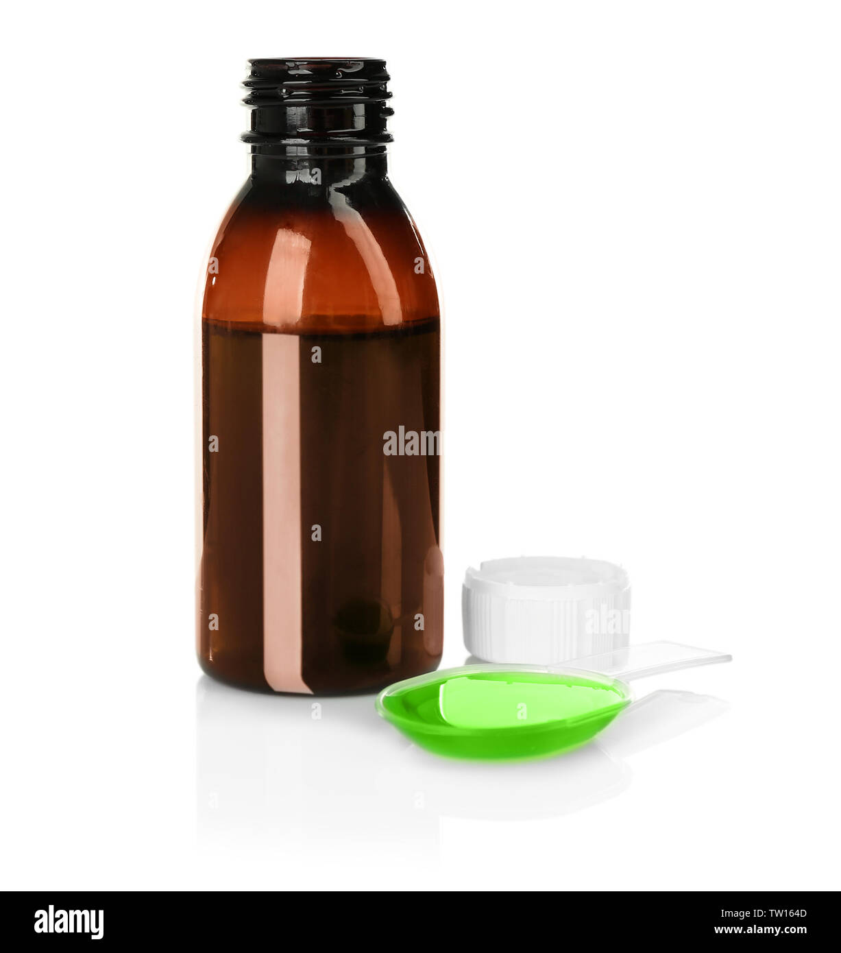 Bottle with cough medicine syrup and poured dose in spoon isolated on