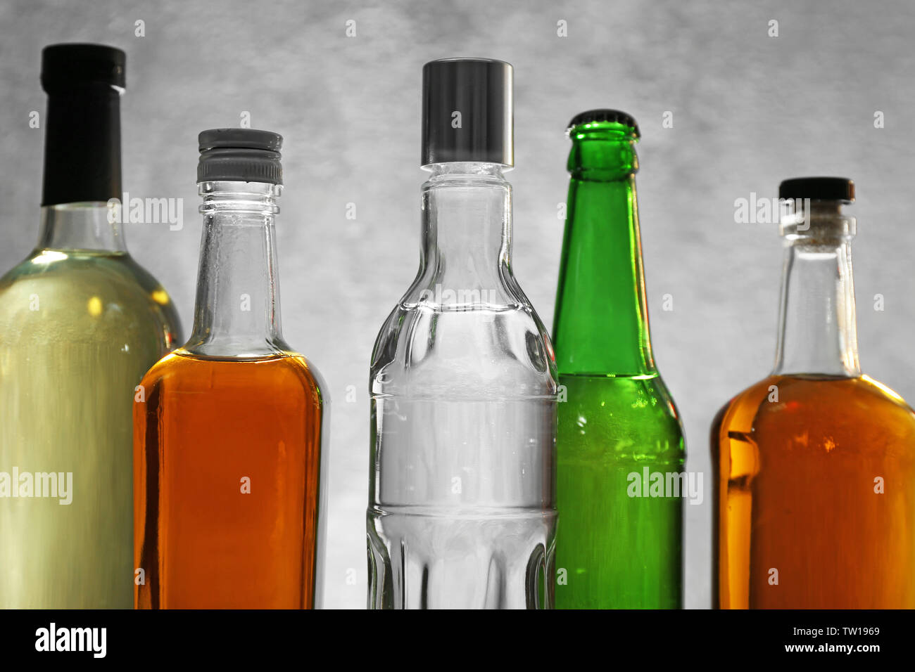 Different bottles of wine and spirits on color background Stock Photo