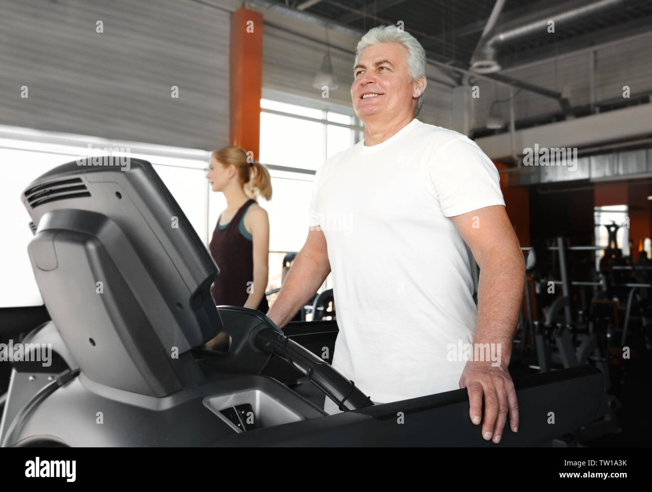 Senior man running on treadmill in gym Stock Photo - Alamy