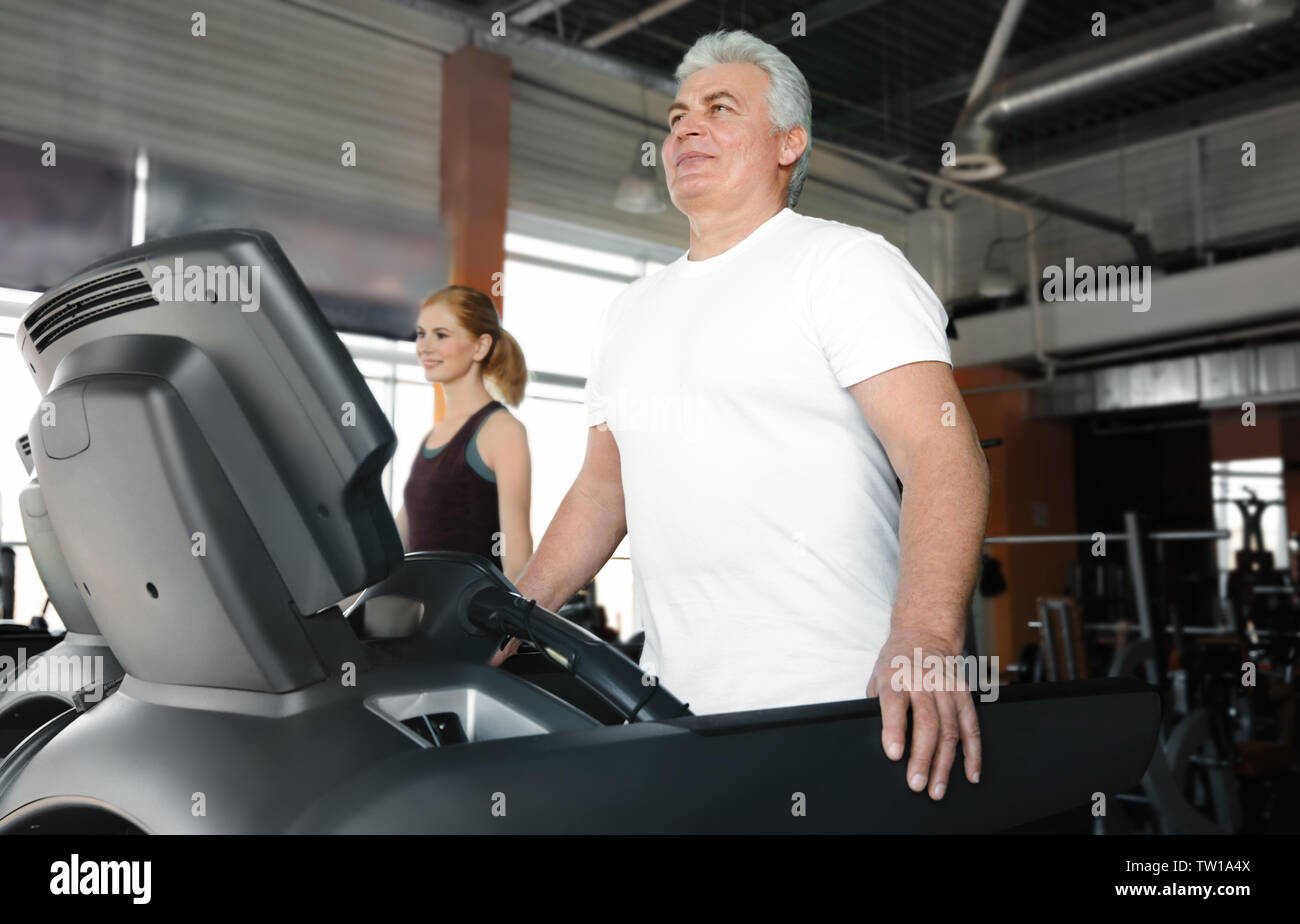 Senior man running on treadmill in gym Stock Photo - Alamy