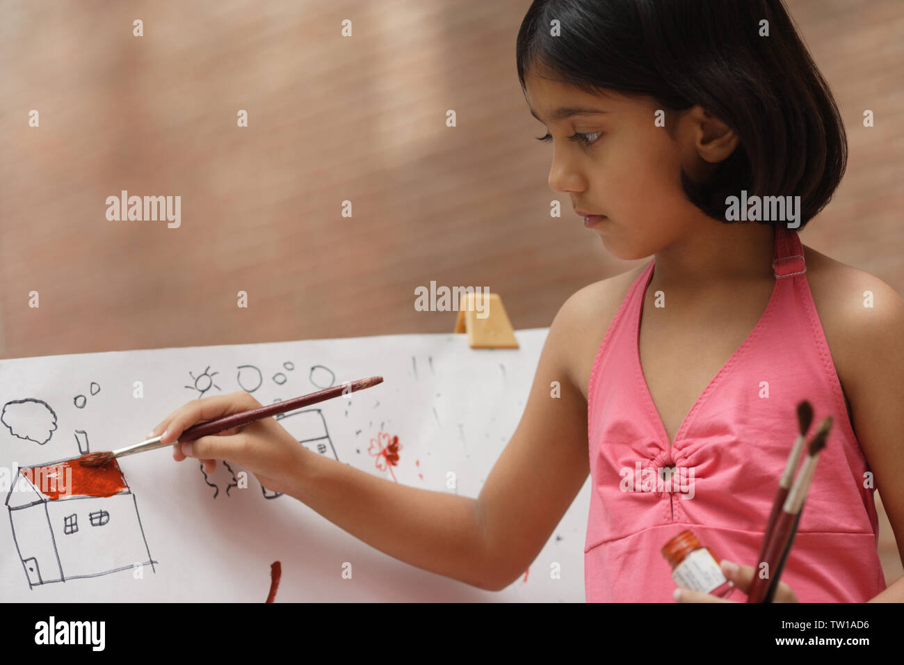 Girl painting at easel Stock Photo - Alamy