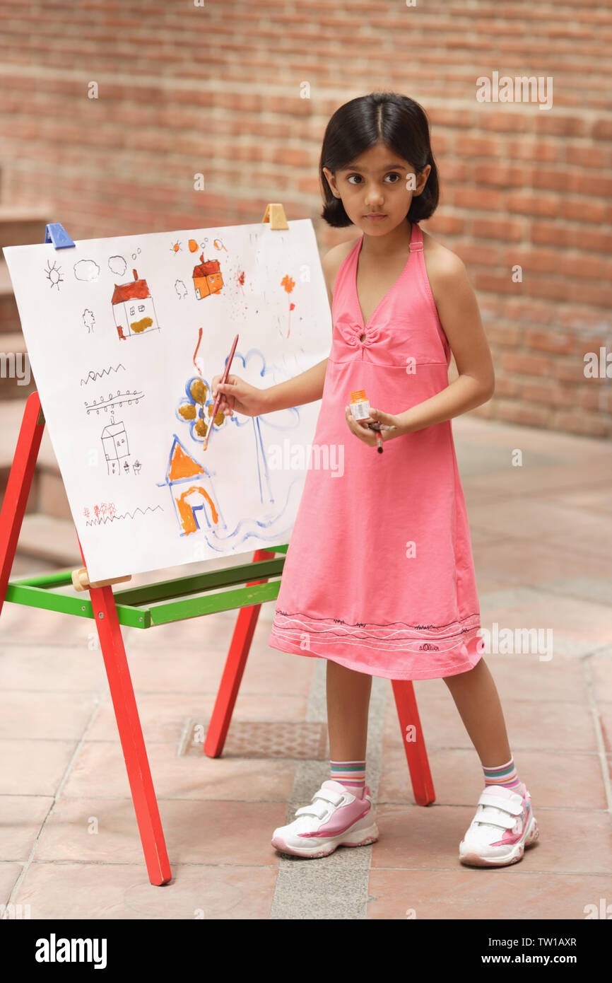 Girl painting at easel Stock Photo - Alamy