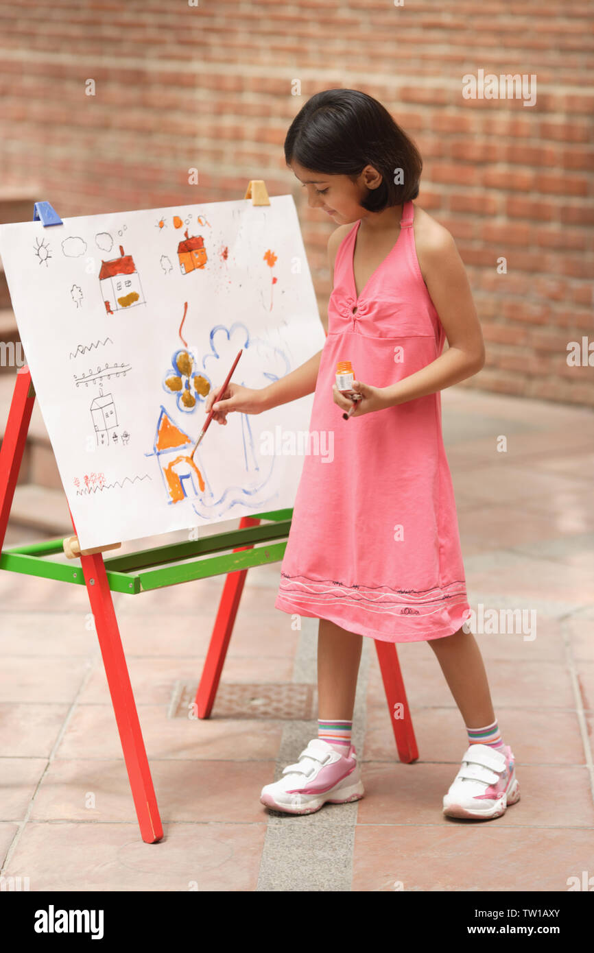 Girl painting at easel Stock Photo - Alamy