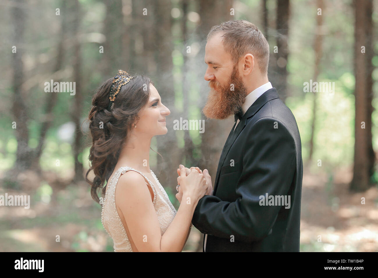 bride and groom standing in the woods.photo with cloud effect Stock ...