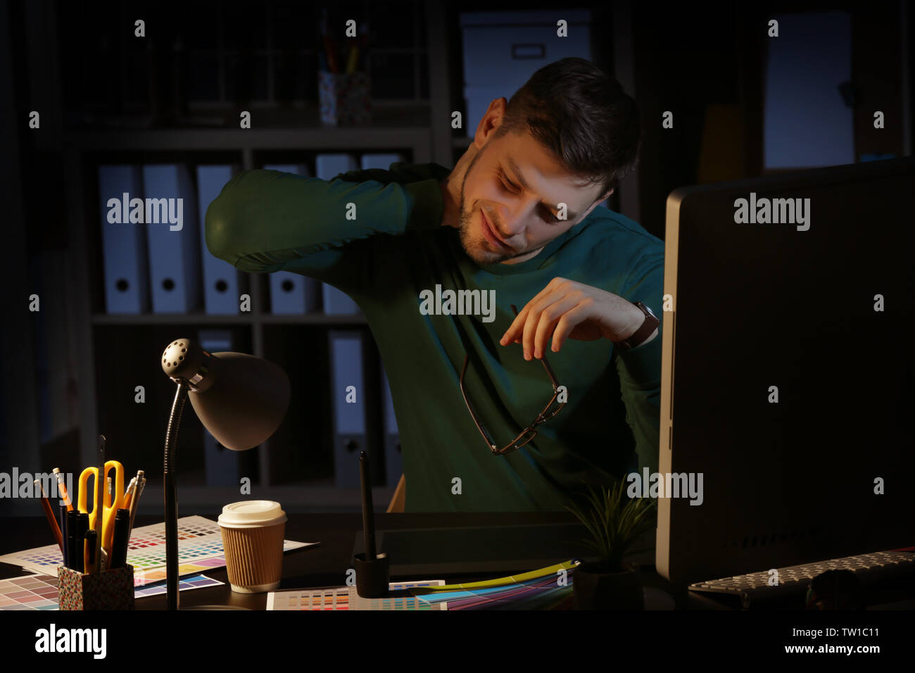 Young male designer working in office Stock Photo