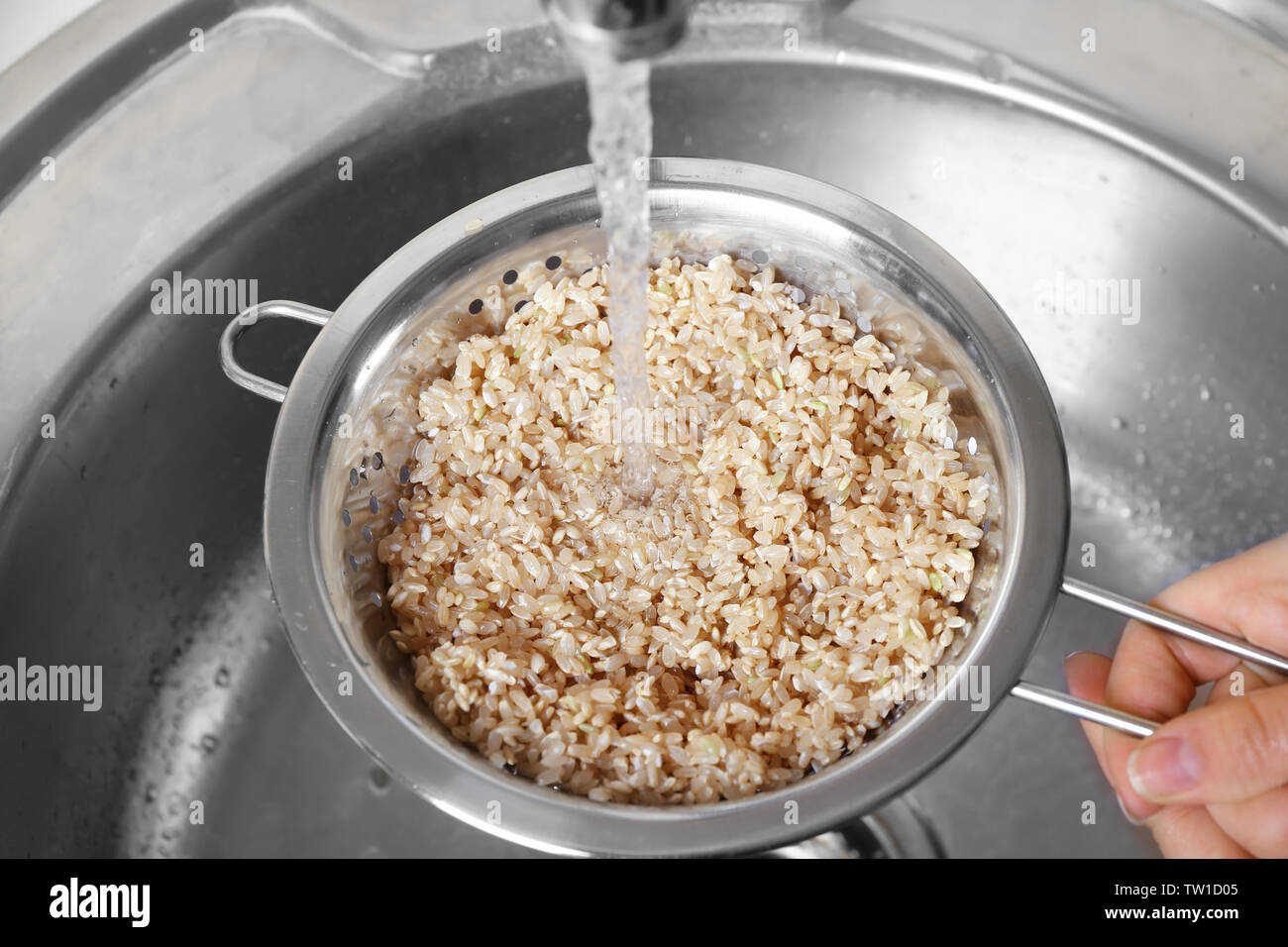 Hand washing rice grains in hi-res stock photography and images - Alamy