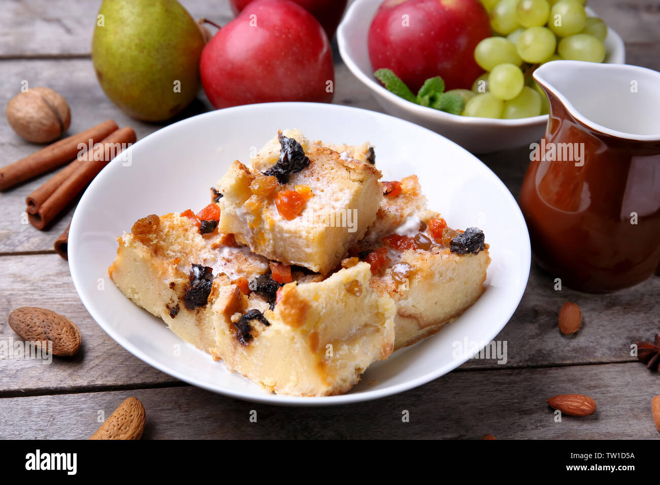 Delicious bread pudding with fruits on table Stock Photo