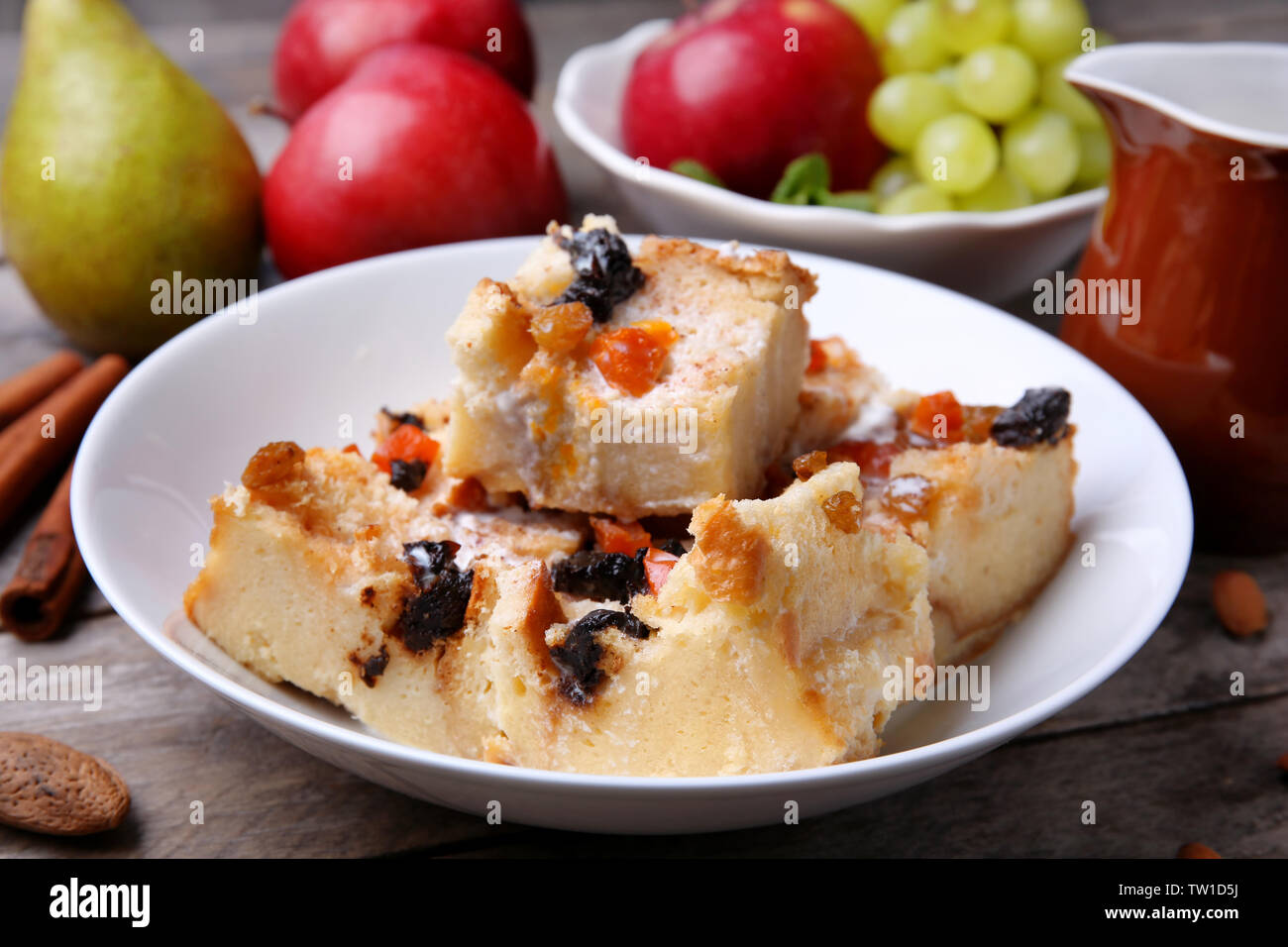 Delicious bread pudding with fruits on table Stock Photo