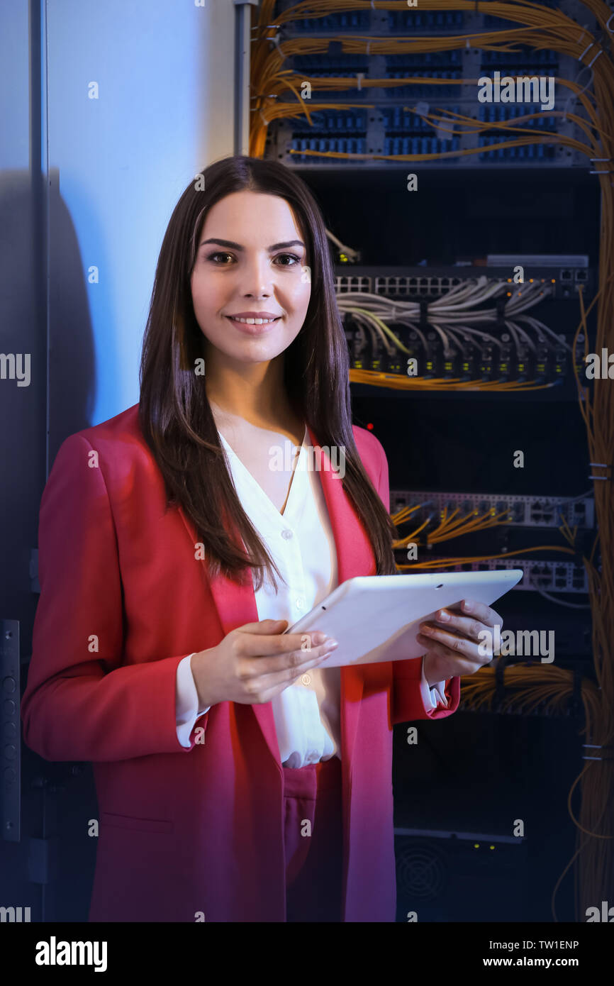 Beautiful young engineer with tablet computer in server room Stock Photo
