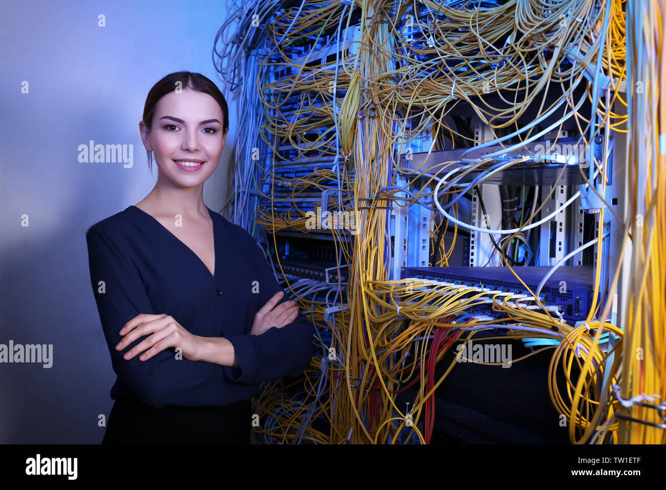 Beautiful young engineer in server room Stock Photo
