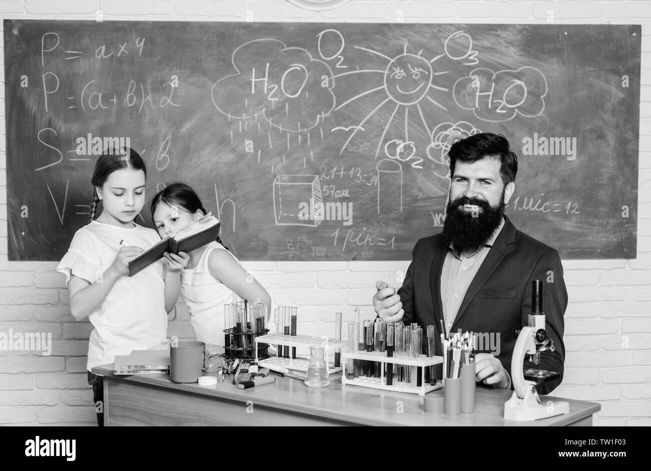 school kids scientist studying science. back to school. happy children teacher. Little kids learning chemistry in school laboratory. students doing science experiments with microscope in lab. Stock Photo