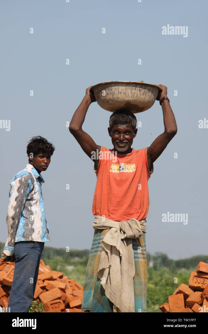 Manual worker working at construction site, India Stock Photo