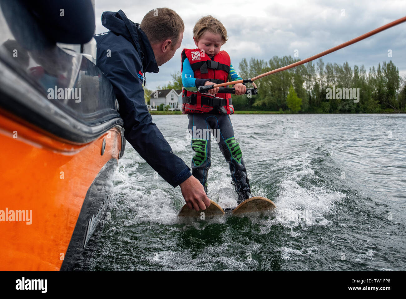 A five year old boy learns to waterski on a lake in the Cotswolds, Gloucestershire, England. Stock Photo