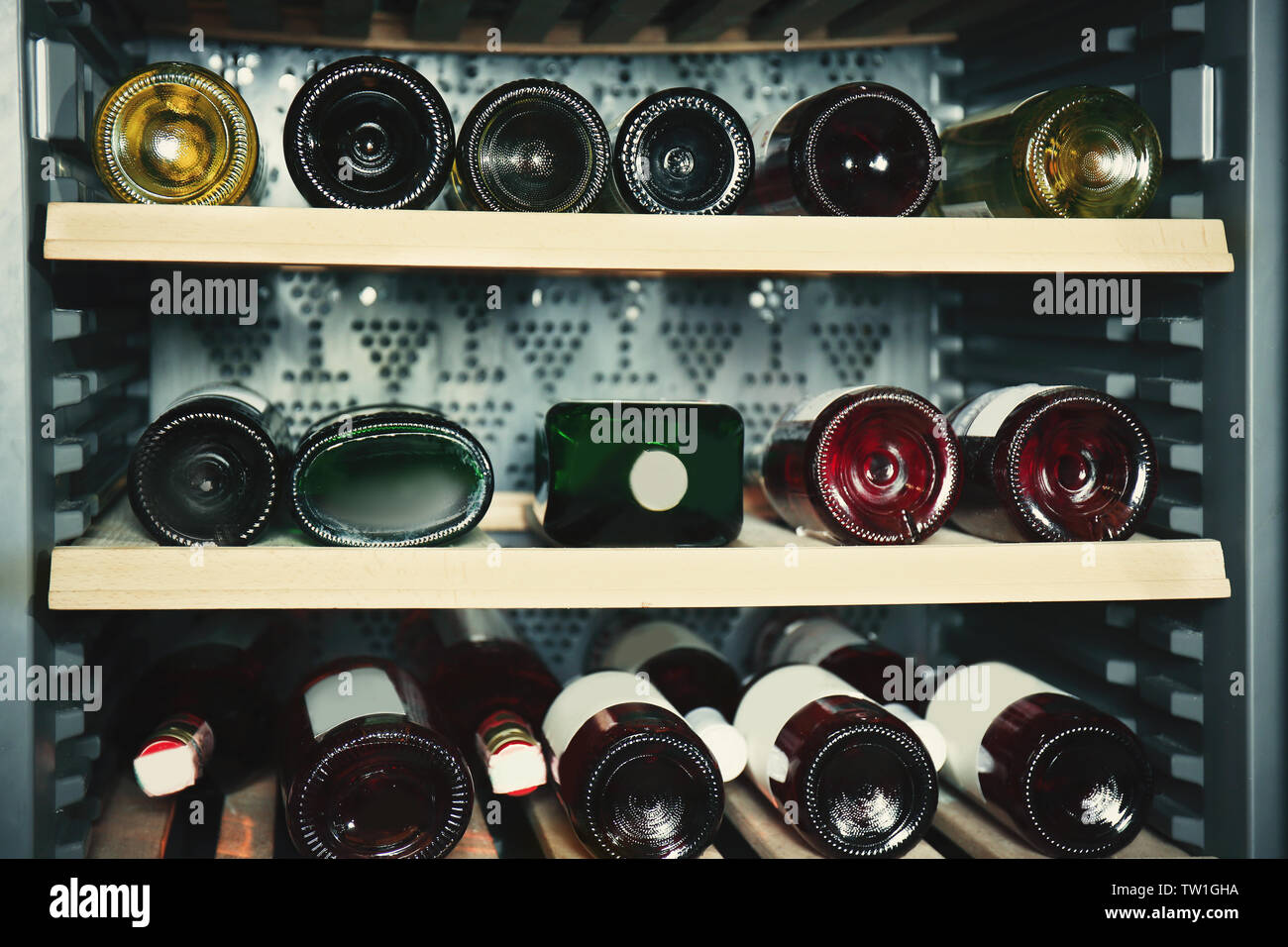 Wine bottles cooling in refrigerator Stock Photo Alamy
