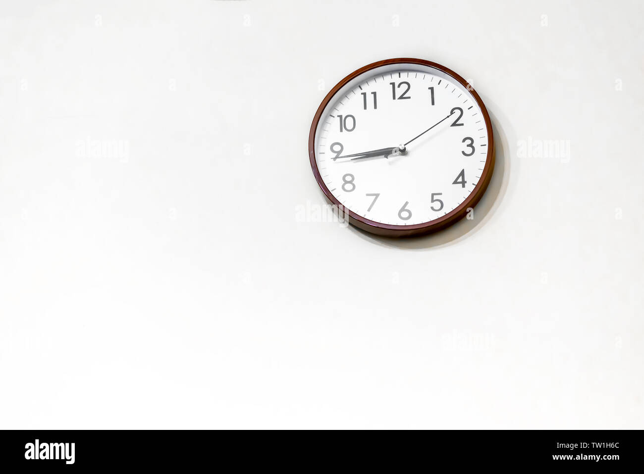 A wall clock on the wall Stock Photo Alamy
