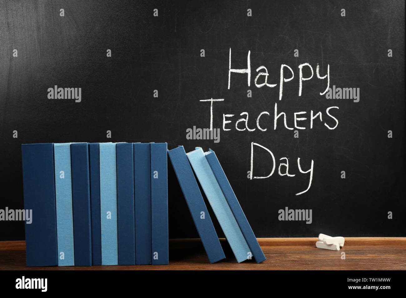 Books on blackboard background. Happy Teacher's Day concept Stock Photo ...