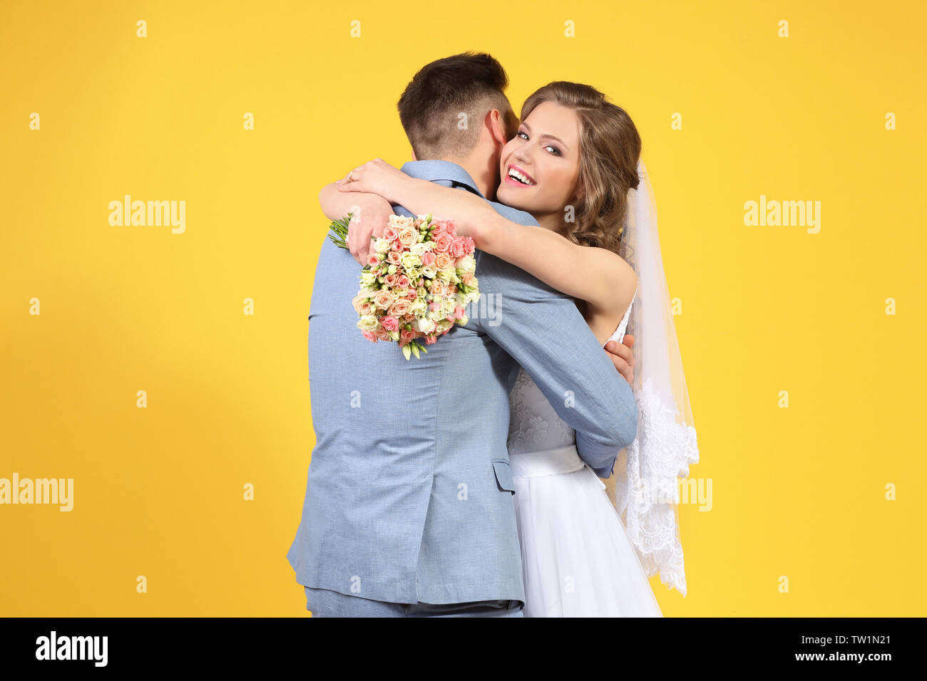 Happy wedding couple on color background Stock Photo - Alamy