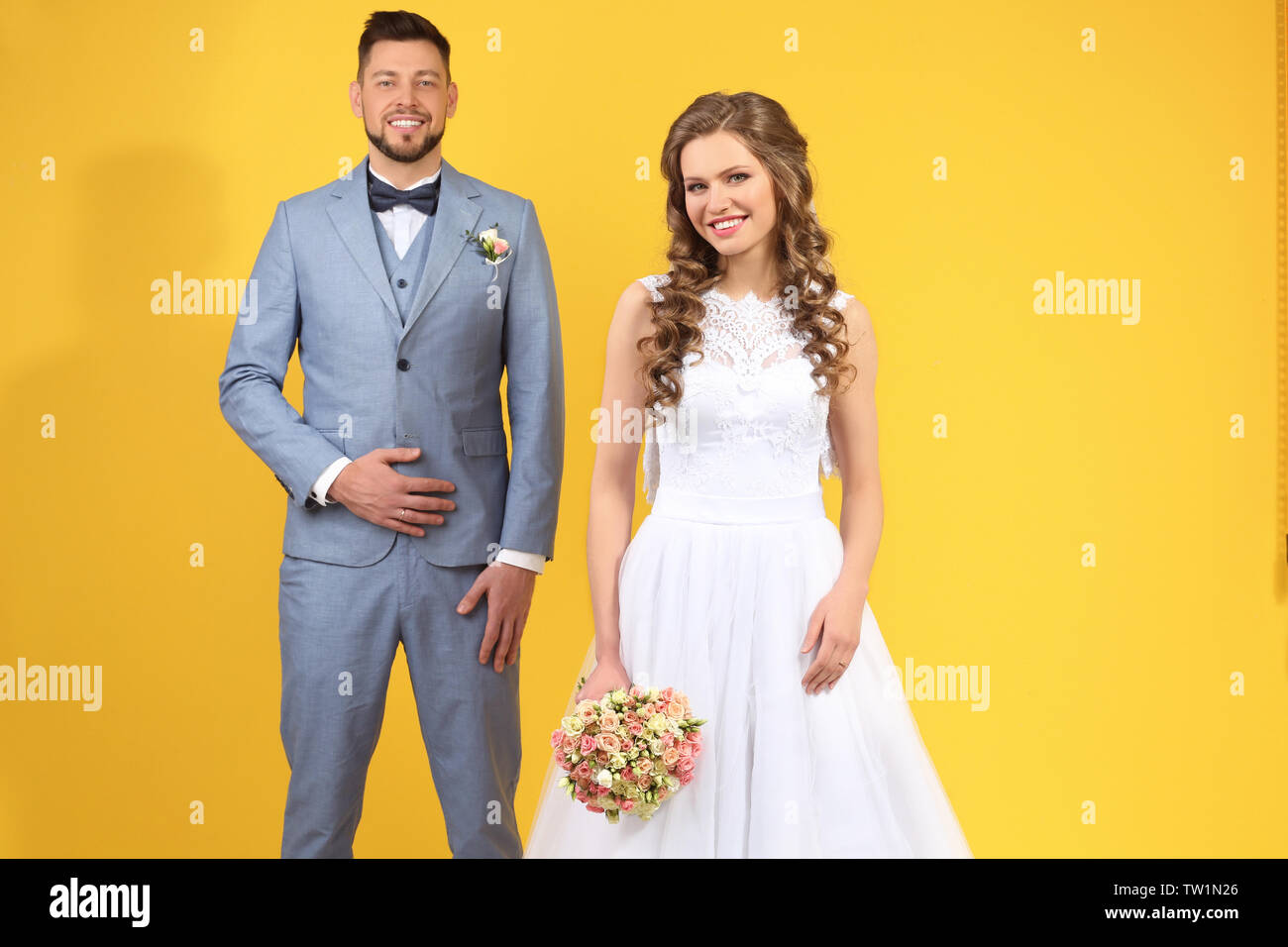 Happy wedding couple on color background Stock Photo - Alamy