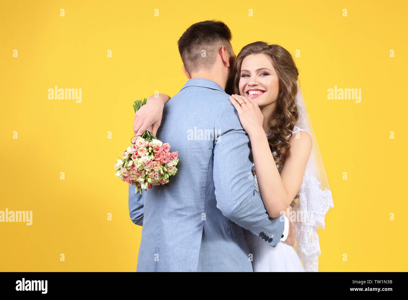 Happy wedding couple on color background Stock Photo - Alamy