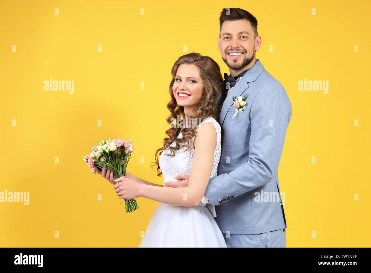 Happy wedding couple on color background Stock Photo - Alamy