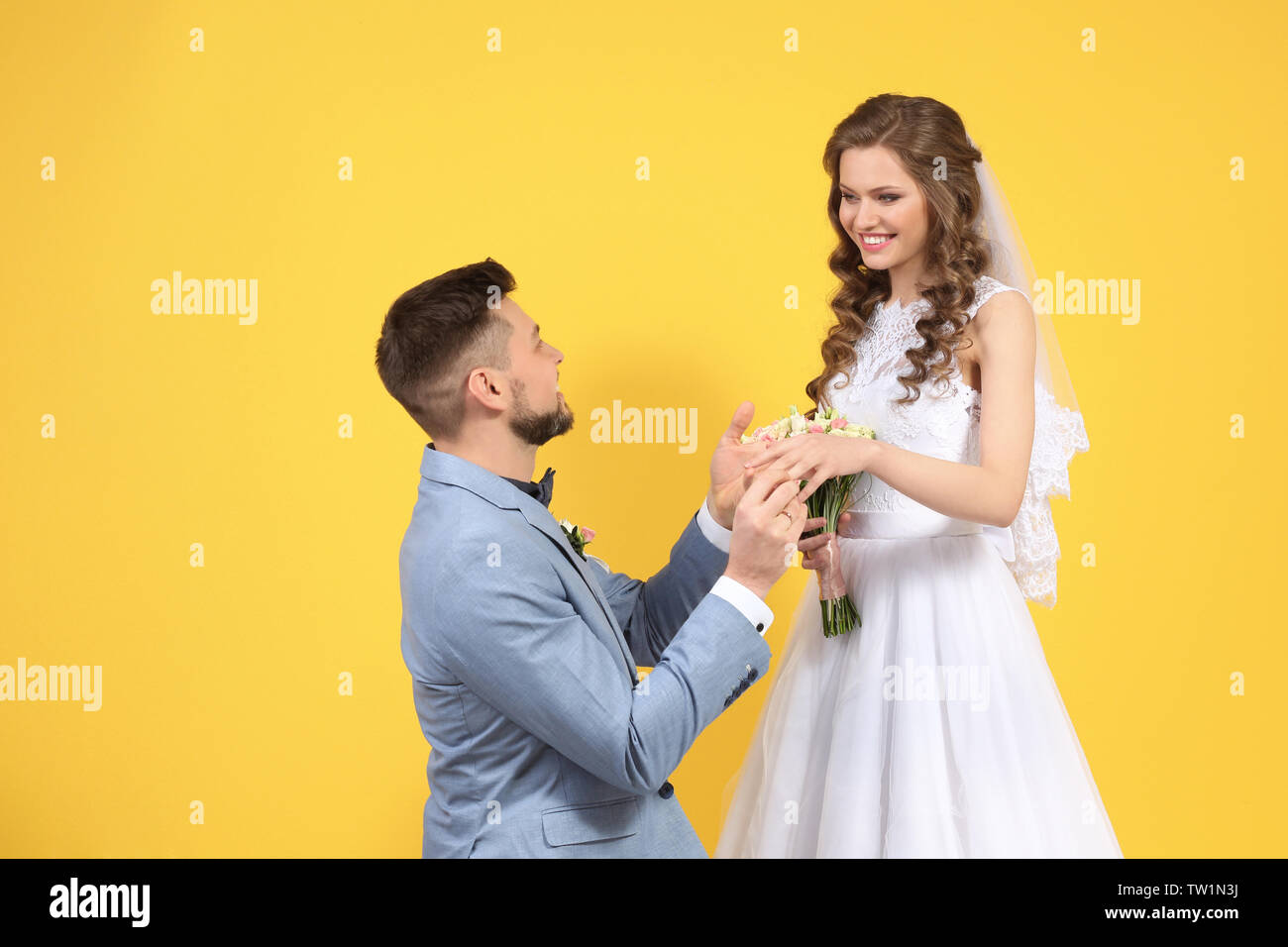 Happy wedding couple on color background Stock Photo - Alamy